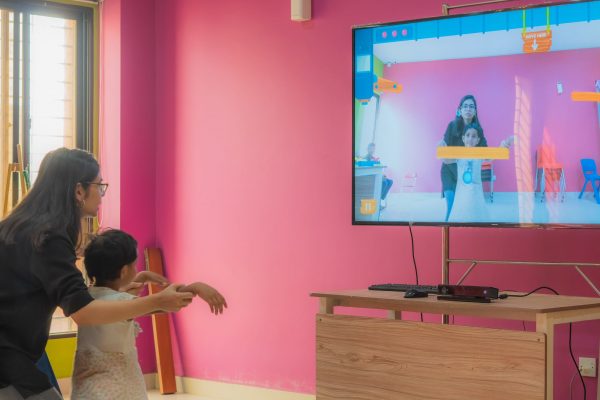 Teacher showing a child how to use WonderTree tech