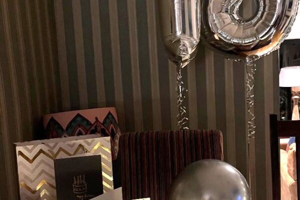 A picture with an 18 birthday balloon and cards